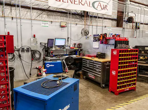 General Air technician service workstation with Miller welding machine, Lincoln Electric tool chest, power tools, and welding parts.